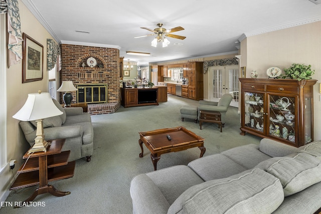 living area with visible vents, a brick fireplace, crown molding, light colored carpet, and french doors