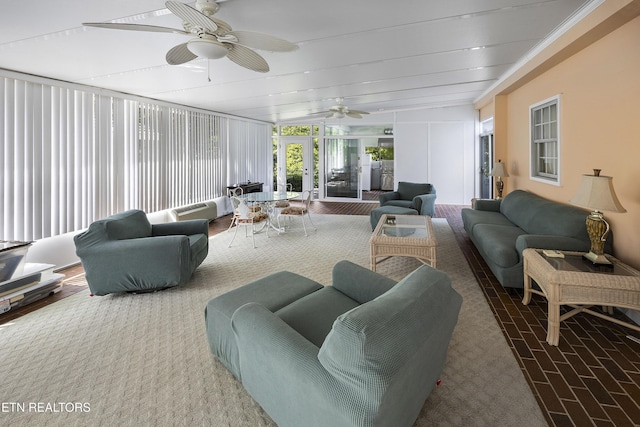 sunroom / solarium featuring beamed ceiling, a ceiling fan, and french doors