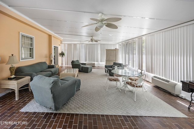 sunroom / solarium featuring a ceiling fan and a wall mounted AC