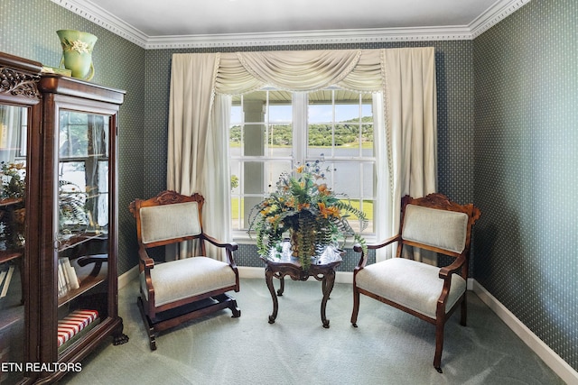 sitting room featuring wallpapered walls, crown molding, baseboards, and carpet floors