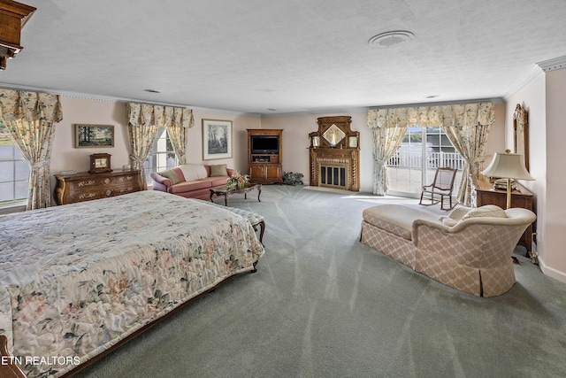 carpeted bedroom featuring access to exterior, a fireplace, a textured ceiling, and crown molding