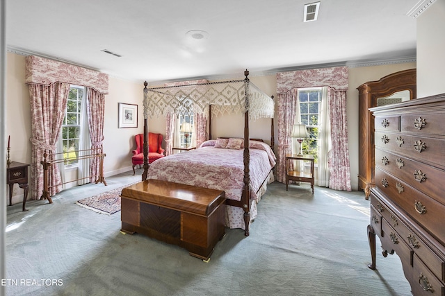 carpeted bedroom with crown molding, baseboards, and visible vents