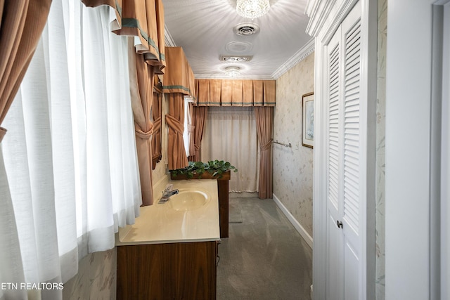 interior space featuring visible vents, wallpapered walls, baseboards, ornamental molding, and vanity