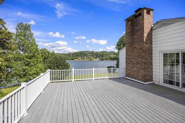 wooden terrace featuring a water view