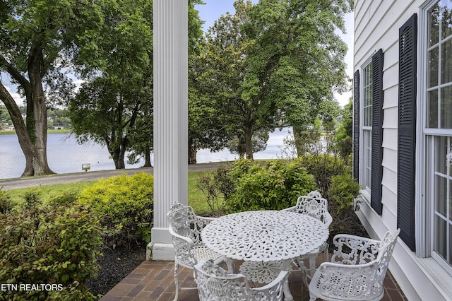 view of patio featuring outdoor dining space and a water view