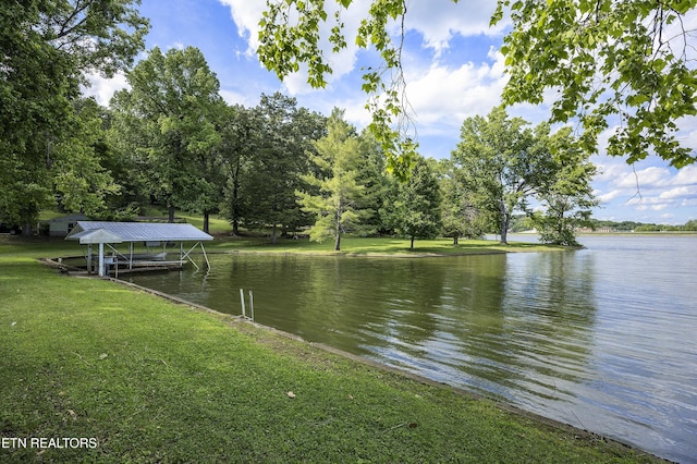 dock area with a yard and a water view