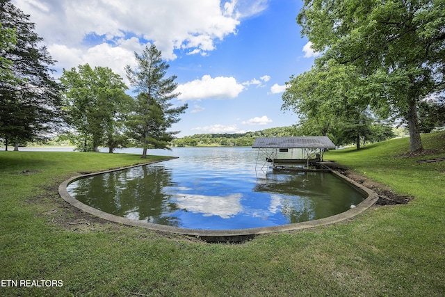 dock area featuring a lawn and a water view