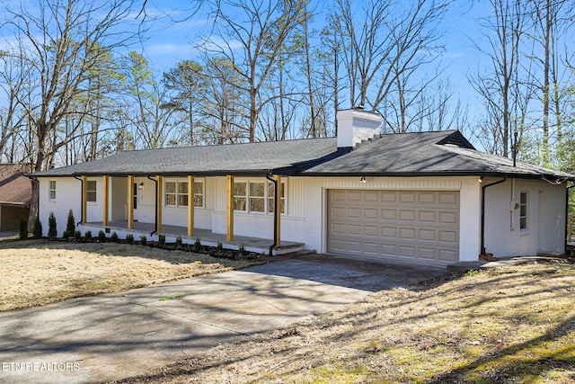 ranch-style home featuring covered porch, a chimney, concrete driveway, and brick siding