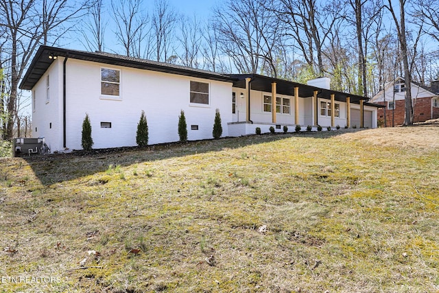 ranch-style home featuring a garage, crawl space, brick siding, and a front lawn