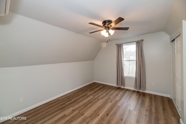 bonus room with baseboards, wood finished floors, a ceiling fan, and vaulted ceiling