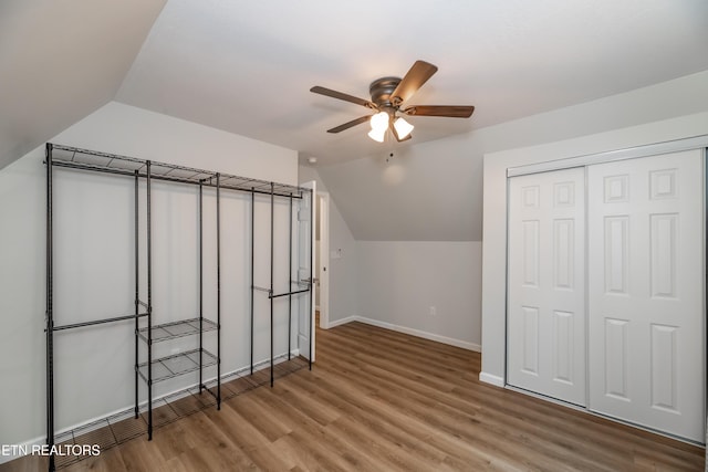 additional living space with ceiling fan, baseboards, lofted ceiling, and wood finished floors