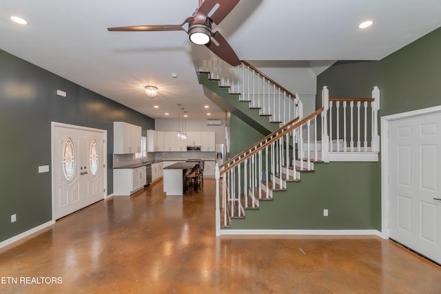 entryway featuring recessed lighting, baseboards, concrete flooring, ceiling fan, and stairs