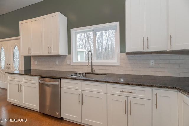 kitchen featuring a sink, tasteful backsplash, stainless steel dishwasher, and white cabinets