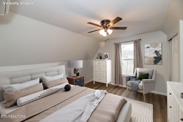 bedroom with baseboards, dark wood-type flooring, lofted ceiling, and a ceiling fan