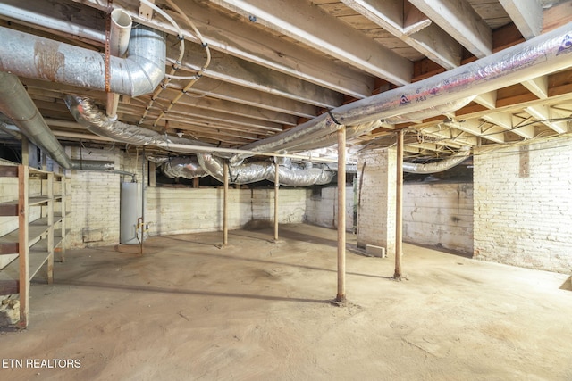 unfinished basement featuring water heater