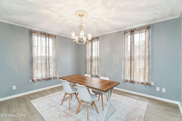 dining room featuring plenty of natural light, ornamental molding, and wood finished floors