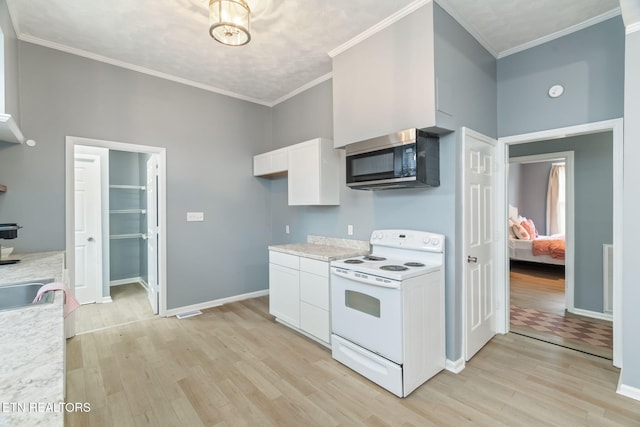 kitchen featuring light countertops, white range with electric cooktop, light wood-style flooring, and white cabinets