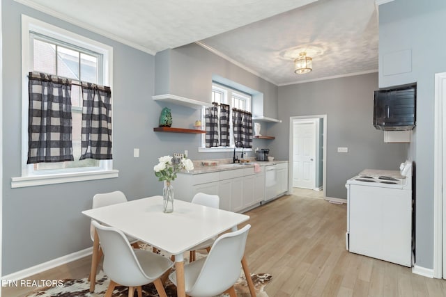 dining space with baseboards, light wood finished floors, a healthy amount of sunlight, and crown molding