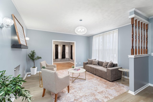 living room with crown molding, baseboards, and wood finished floors