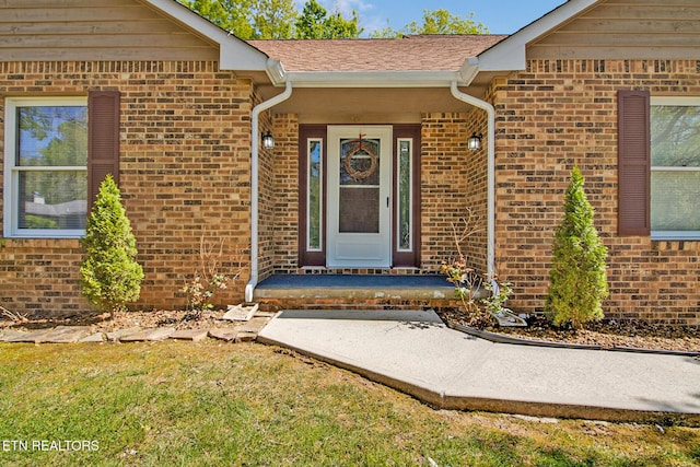 doorway to property with brick siding