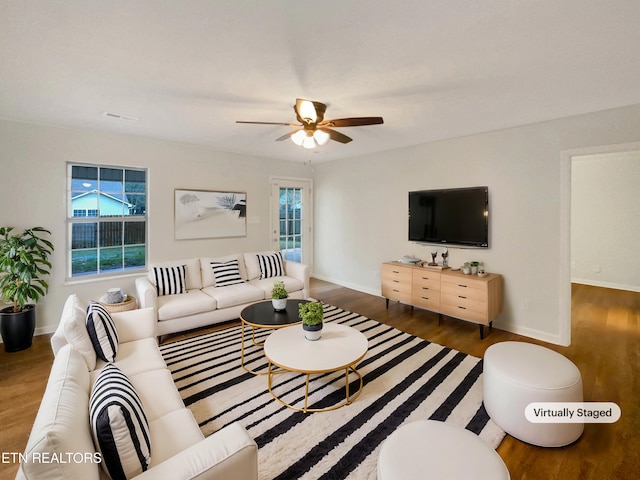 living room with a healthy amount of sunlight, ceiling fan, baseboards, and wood finished floors