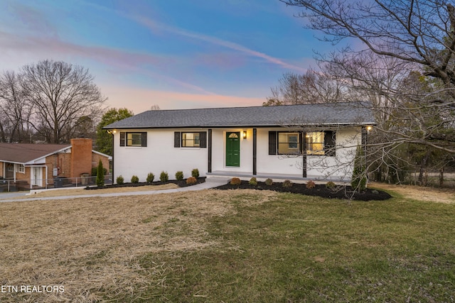 ranch-style house featuring a lawn