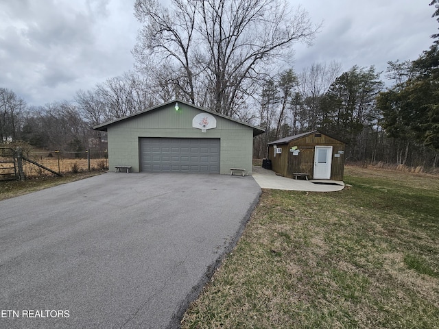 detached garage featuring fence