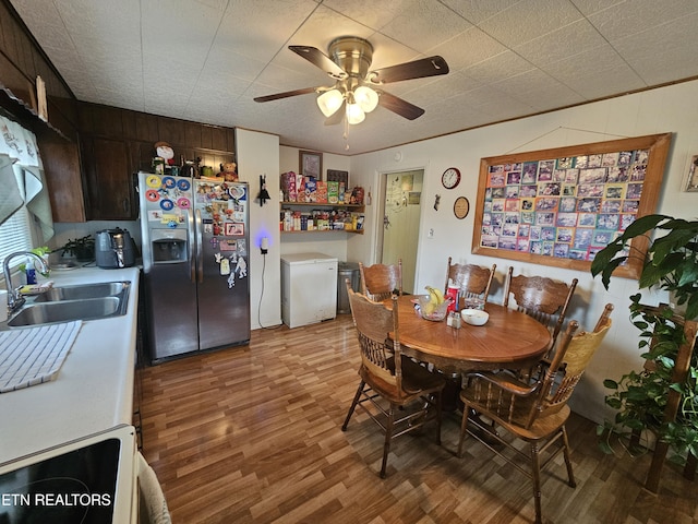 dining room with ceiling fan and wood finished floors