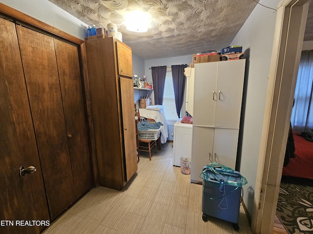 interior space featuring washer / dryer and a textured ceiling