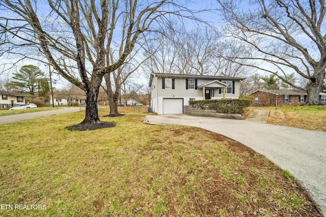 view of front of property with a garage, concrete driveway, and a front yard