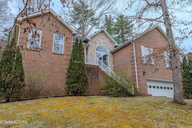 view of front of property featuring a garage, stone siding, stairs, a front lawn, and brick siding