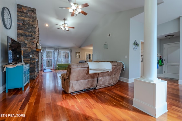 living room featuring decorative columns, high vaulted ceiling, ceiling fan, and wood finished floors