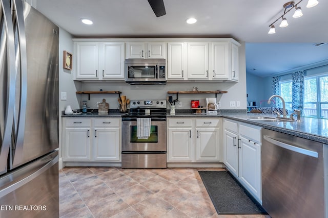 kitchen with visible vents, stainless steel appliances, white cabinetry, a sink, and recessed lighting