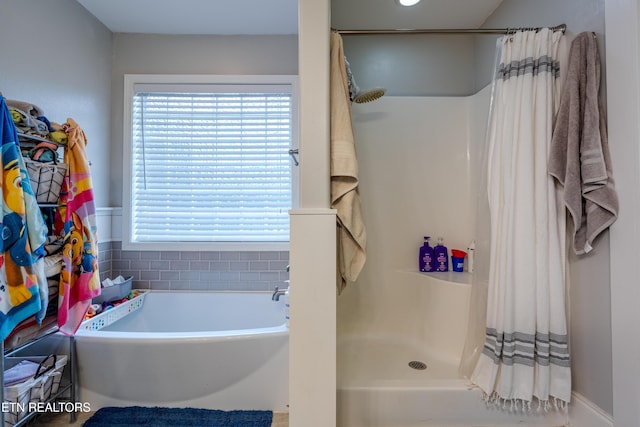 full bathroom with curtained shower and a bath