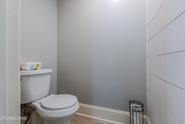 bathroom with baseboards and toilet