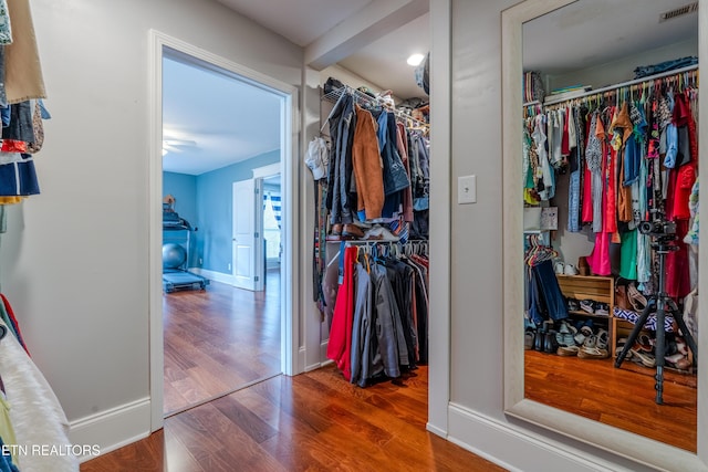 spacious closet featuring visible vents and wood finished floors