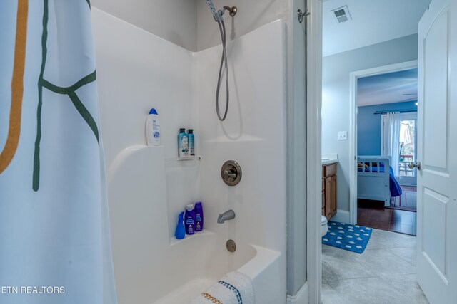 bathroom with washtub / shower combination, tile patterned flooring, visible vents, and vanity