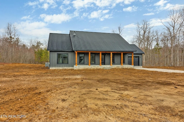 rear view of house featuring metal roof