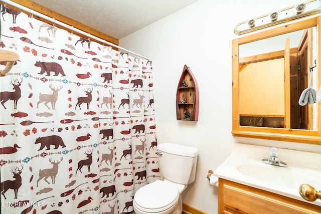 bathroom with toilet, curtained shower, a textured ceiling, and vanity