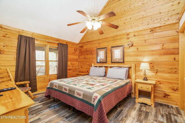 bedroom featuring vaulted ceiling, ceiling fan, wood finished floors, and wooden walls