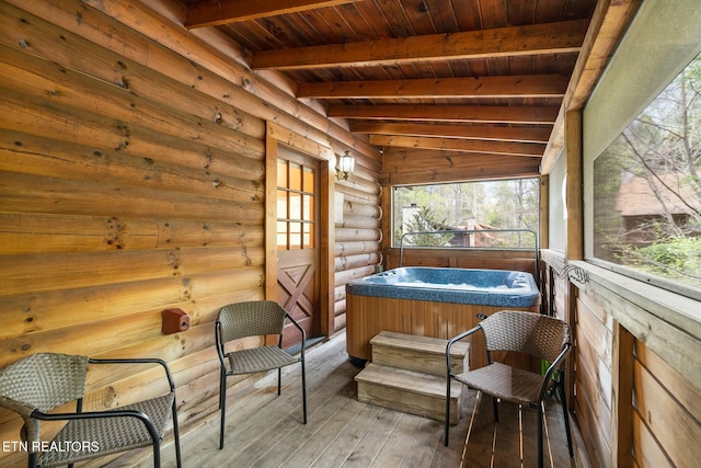 sunroom / solarium featuring beamed ceiling, wood ceiling, and a hot tub