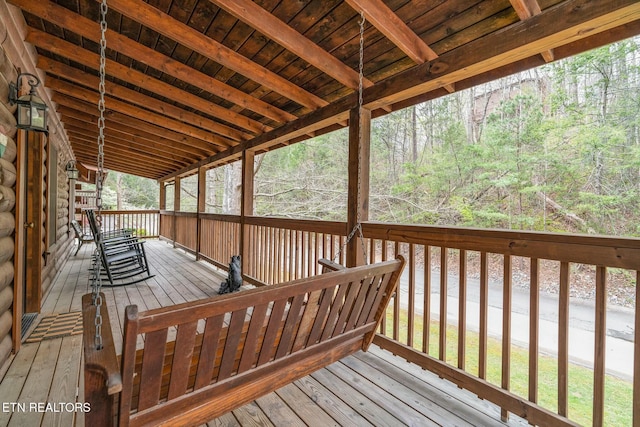 wooden deck with a wooded view