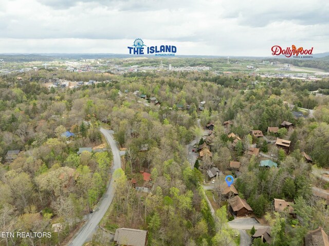 bird's eye view featuring a wooded view