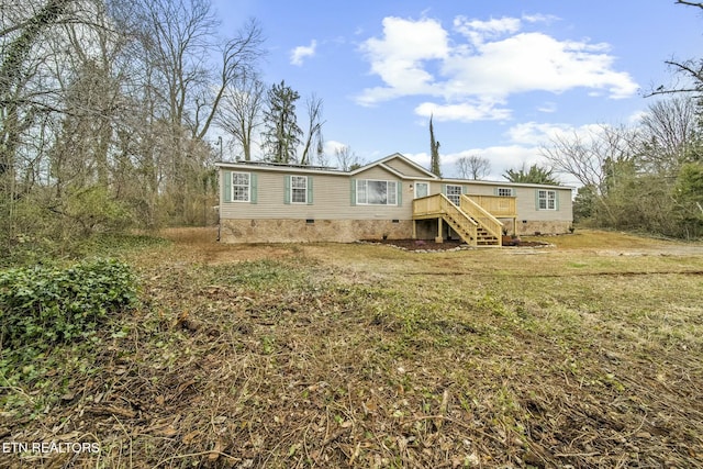 view of front of house featuring crawl space and stairway