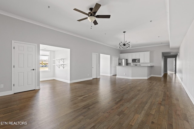 unfurnished living room featuring ceiling fan with notable chandelier, dark wood-type flooring, baseboards, and ornamental molding