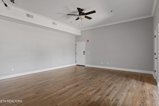 empty room with visible vents, wood finished floors, a ceiling fan, and crown molding