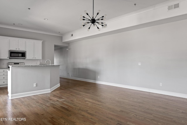 kitchen with visible vents, ornamental molding, decorative backsplash, a notable chandelier, and stainless steel appliances