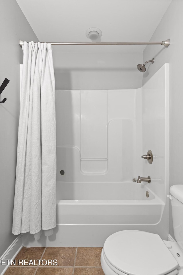 full bathroom featuring tile patterned flooring, toilet, and shower / bath combo