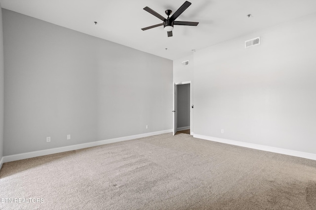 empty room with visible vents, baseboards, ceiling fan, and carpet flooring