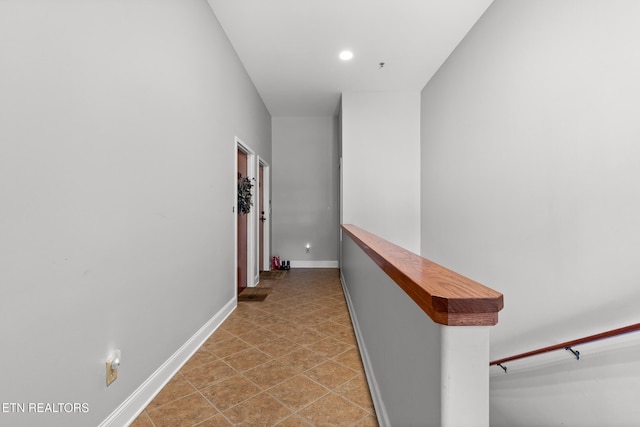 hallway with recessed lighting and baseboards